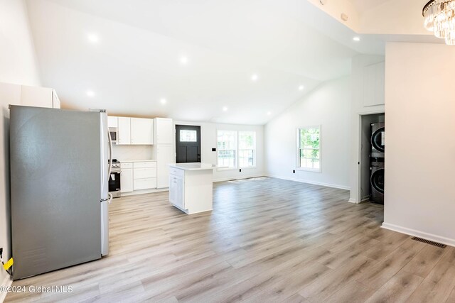 15 Schaffer Dr, Colonie, NY 12047 - kitchen with appliances with stainless steel finishes, stacked washing machine and dryer, recessed lighting, a kitchen island, and lofted ceiling