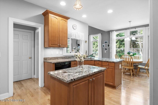264 Edie Rd, Wilton, NY 12866 - kitchen with black dishwasher, a peninsula, light stone counters, a center island, and light wood finished floors