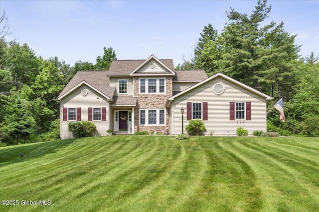 264 Edie Rd, Wilton, NY 12866 - view of front of house with stone siding, a front yard, and a shingled roof