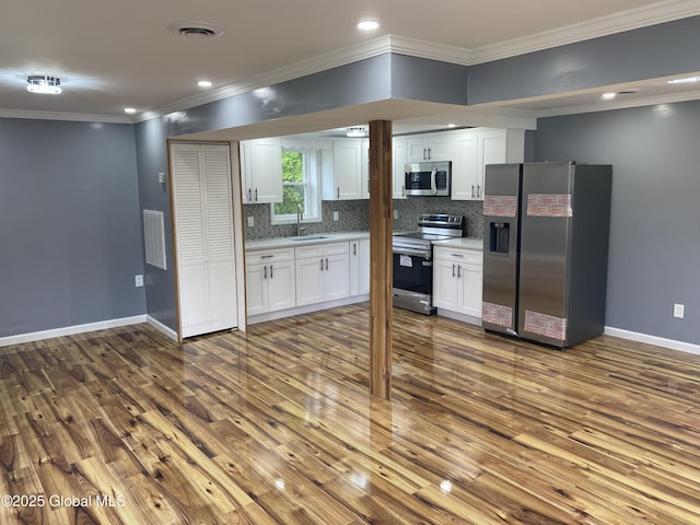 2112 Gray St, Rotterdam, NY 12306 - kitchen featuring appliances with stainless steel finishes, baseboards, dark wood-type flooring, a sink, and white cabinetry