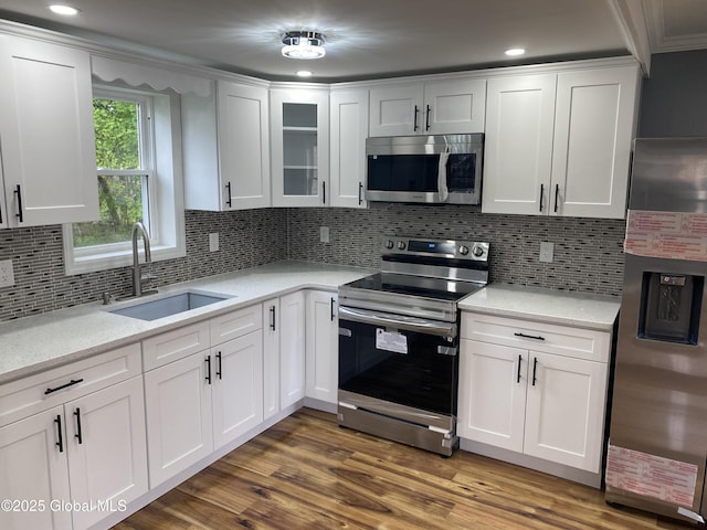 2112 Gray St, Rotterdam, NY 12306 - kitchen featuring stainless steel appliances, a sink, white cabinetry, decorative backsplash, and recessed lighting