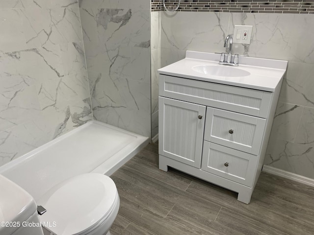 2112 Gray St, Rotterdam, NY 12306 - full bathroom with vanity, toilet, a shower stall, wood finished floors, and tile walls