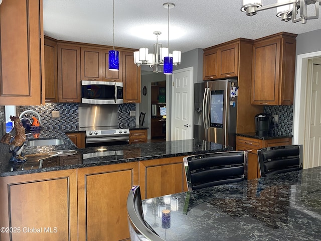 6 Bishops Ct, Queensbury, NY 12804 - kitchen with appliances with stainless steel finishes, a chandelier, a sink, tasteful backsplash, and brown cabinets