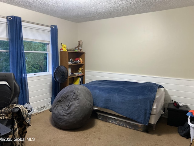 6 Bishops Ct, Queensbury, NY 12804 - carpeted bedroom featuring a textured ceiling and a wainscoted wall
