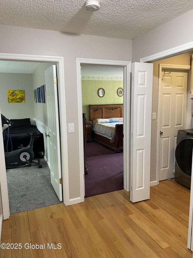 6 Bishops Ct, Queensbury, NY 12804 - corridor with washer / clothes dryer, light wood-type flooring, and a textured ceiling