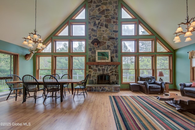 324 County Highway 112, Bleecker, NY 12078 - living room featuring a chandelier, high vaulted ceiling, wood finished floors, and a fireplace