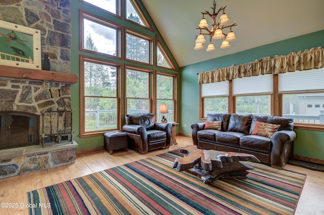 324 County Highway 112, Bleecker, NY 12078 - living area with a chandelier, wood finished floors, a fireplace, baseboards, and high vaulted ceiling