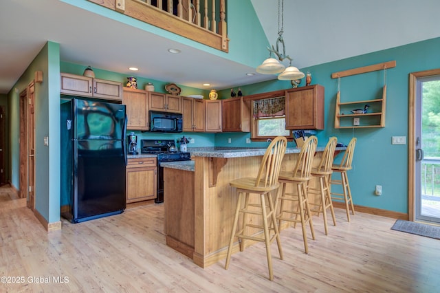 324 County Highway 112, Bleecker, NY 12078 - kitchen with black appliances, light wood finished floors, brown cabinets, vaulted ceiling, and recessed lighting