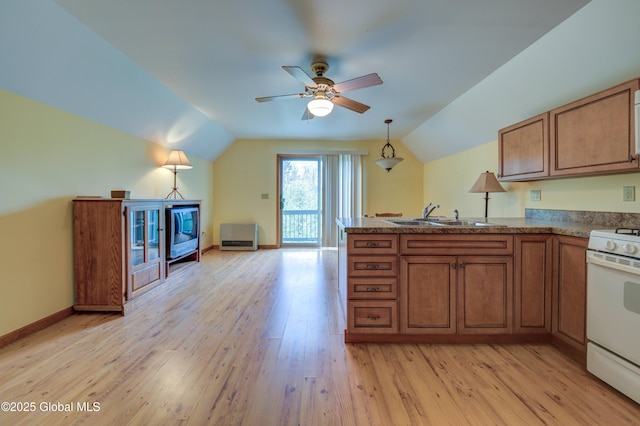 324 County Highway 112, Bleecker, NY 12078 - kitchen featuring a sink, brown cabinetry, white gas stove, a peninsula, and vaulted ceiling