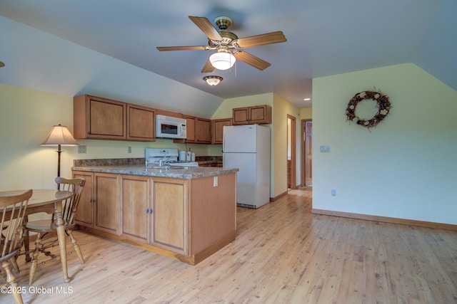 324 County Highway 112, Bleecker, NY 12078 - kitchen with white appliances, a peninsula, dark countertops, vaulted ceiling, and light wood-style flooring