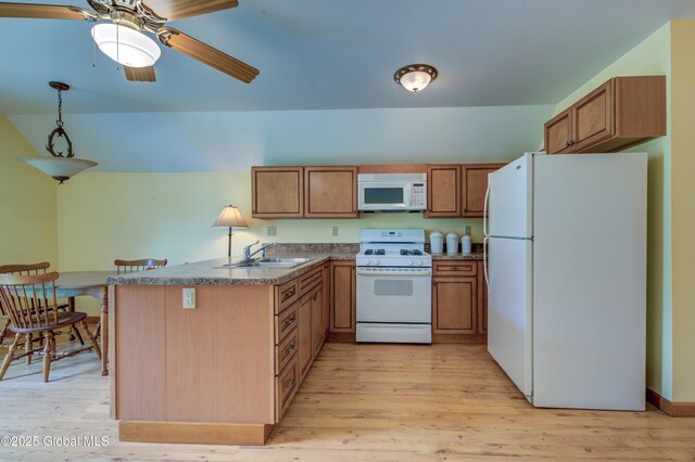 324 County Highway 112, Bleecker, NY 12078 - kitchen with white appliances, a sink, a peninsula, and brown cabinetry