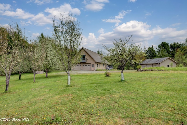 324 County Highway 112, Bleecker, NY 12078 - view of grassy yard featuring a garage and driveway
