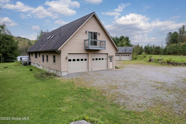 324 County Highway 112, Bleecker, NY 12078 - view of side of property with a balcony, a lawn, and a garage