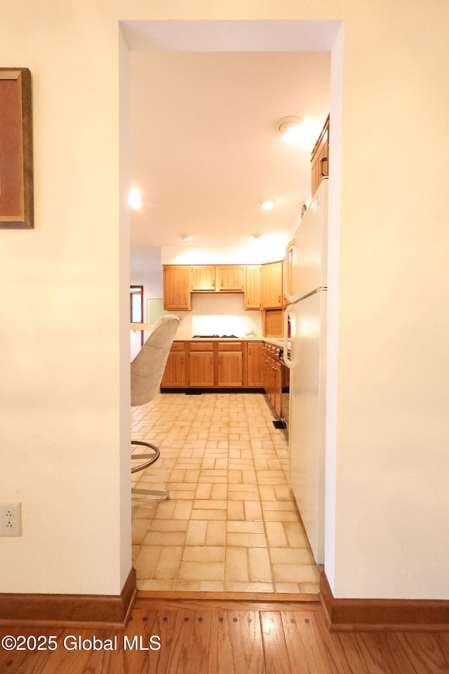 441 E Kelm Pond Rd, Warrensburg, NY 12885 - kitchen featuring freestanding refrigerator, light countertops, baseboards, stovetop, and recessed lighting