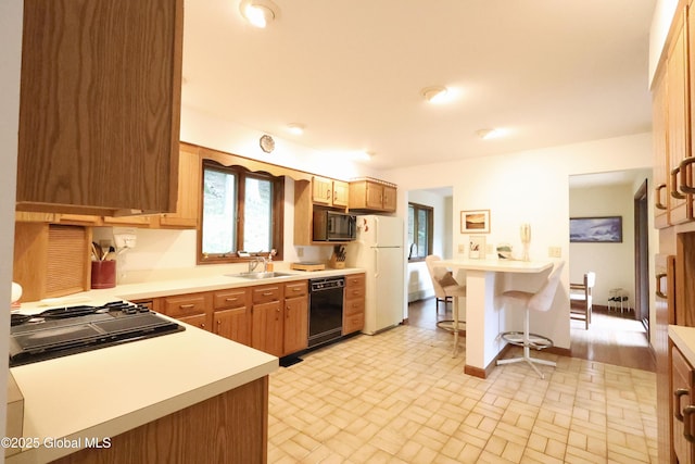 441 E Kelm Pond Rd, Warrensburg, NY 12885 - kitchen with black appliances, a sink, light countertops, and brick patterned flooring
