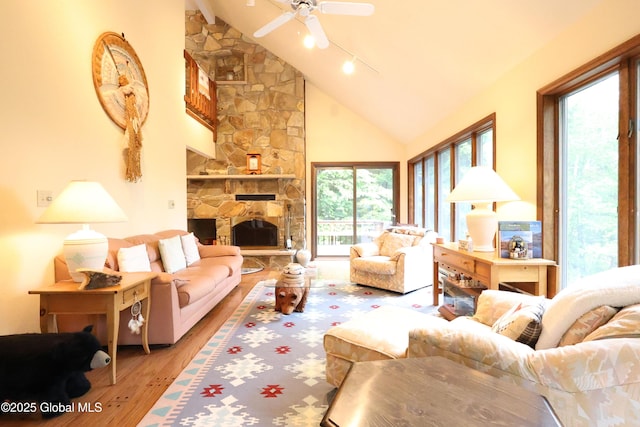 441 E Kelm Pond Rd, Warrensburg, NY 12885 - living area with hardwood / wood-style flooring, ceiling fan, high vaulted ceiling, and a fireplace