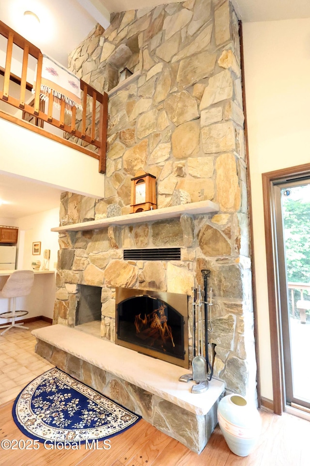 441 E Kelm Pond Rd, Warrensburg, NY 12885 - detailed view of a stone fireplace, baseboards, and beamed ceiling