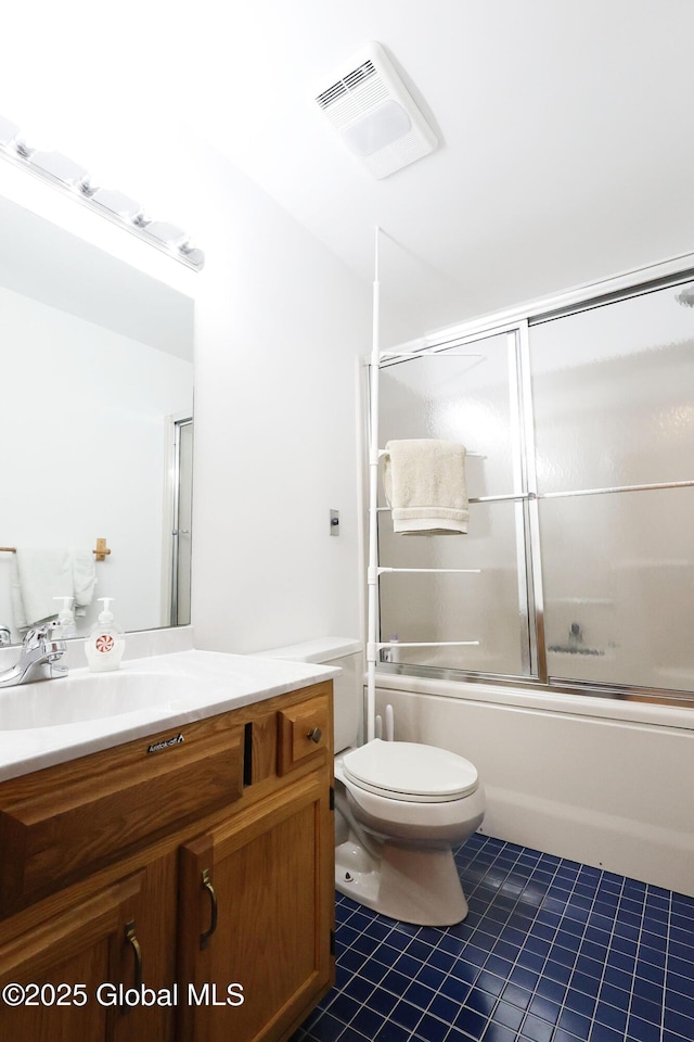441 E Kelm Pond Rd, Warrensburg, NY 12885 - bathroom featuring vanity, tile patterned floors, toilet, and enclosed tub / shower combo