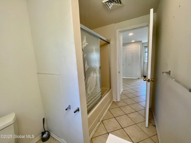 6963 Fuller Station Rd, Schenectady, NY 12303 - bathroom featuring tile patterned floors, toilet, combined bath / shower with glass door, and baseboards