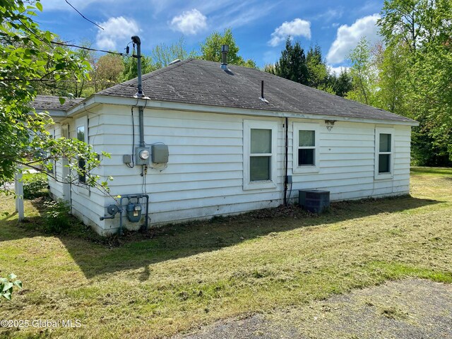 6963 Fuller Station Rd, Schenectady, NY 12303 - back of property featuring a lawn, central AC unit, and a shingled roof