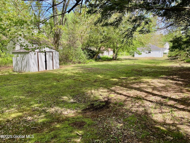 6963 Fuller Station Rd, Schenectady, NY 12303 - view of green lawn with a storage unit and an outdoor structure