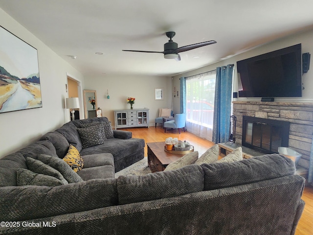 1 Laurel Rd, Moreau, NY 12828 - living room with wood finished floors, a ceiling fan, and a stone fireplace