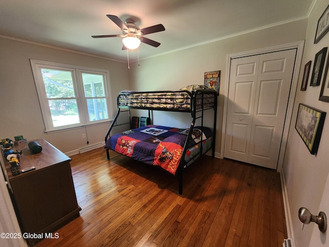1 Laurel Rd, Moreau, NY 12828 - bedroom featuring dark wood-type flooring, crown molding, baseboards, a baseboard heating unit, and a ceiling fan