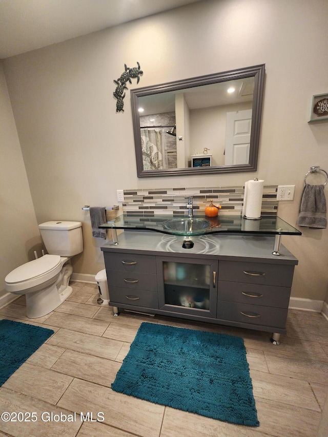 1 Laurel Rd, Moreau, NY 12828 - bathroom with baseboards, wood finish floors, toilet, and vanity