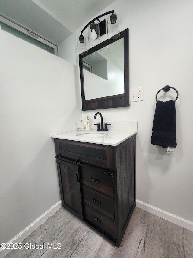 1 Laurel Rd, Moreau, NY 12828 - bathroom featuring wood finished floors, baseboards, and vanity
