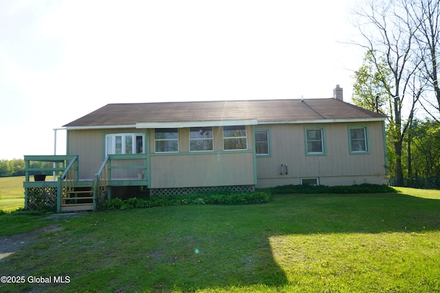 40 W Starbuck Ln, Fort Ann, NY 12827 - rear view of property featuring a deck, a yard, and a chimney