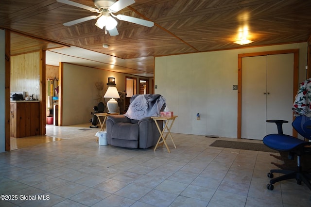 40 W Starbuck Ln, Fort Ann, NY 12827 - living room featuring wooden walls, a ceiling fan, and an ornate ceiling