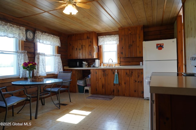40 W Starbuck Ln, Fort Ann, NY 12827 - kitchen with healthy amount of natural light, freestanding refrigerator, wooden ceiling, a sink, and brown cabinets