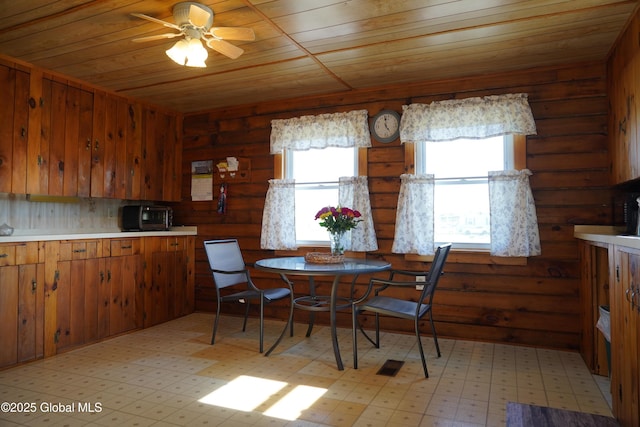 40 W Starbuck Ln, Fort Ann, NY 12827 - dining area featuring wood ceiling, a ceiling fan, rustic walls, and light flooring