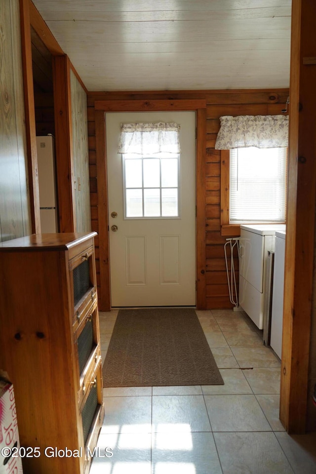 40 W Starbuck Ln, Fort Ann, NY 12827 - entryway featuring independent washer and dryer, healthy amount of natural light, light tile patterned flooring, and rustic walls