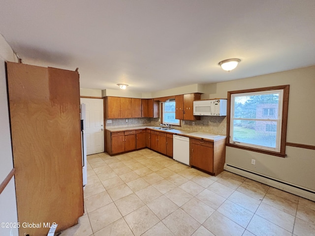 3 Schuyler Ave, Ravena, NY 12143 - kitchen featuring white appliances, a sink, baseboard heating, decorative backsplash, and plenty of natural light