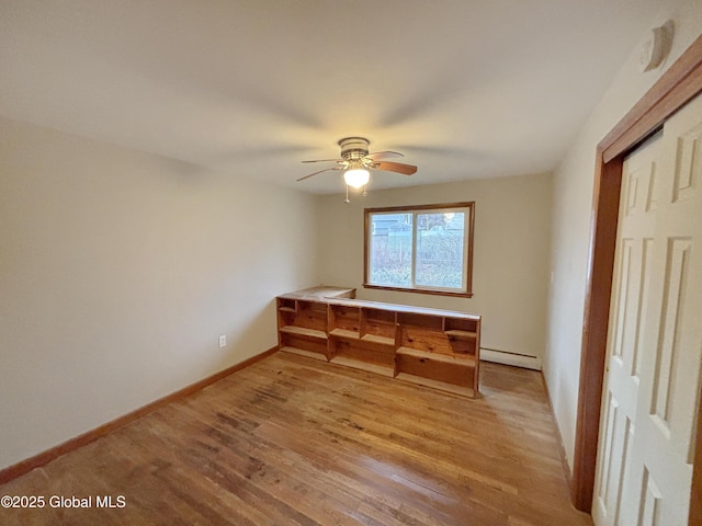 3 Schuyler Ave, Ravena, NY 12143 - unfurnished bedroom with baseboard heating, light wood-style flooring, baseboards, ceiling fan, and a closet
