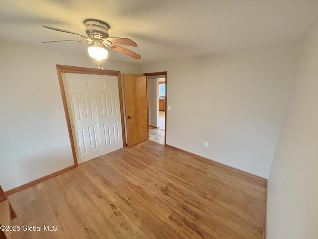 3 Schuyler Ave, Ravena, NY 12143 - unfurnished bedroom featuring light wood-style floors, a closet, baseboards, and ceiling fan