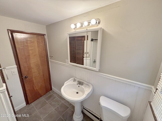 3 Schuyler Ave, Ravena, NY 12143 - bathroom with baseboard heating, wainscoting, toilet, and tile patterned floors