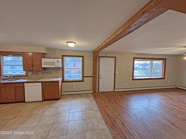 3 Schuyler Ave, Ravena, NY 12143 - kitchen featuring white appliances, a sink, a baseboard heating unit, and plenty of natural light