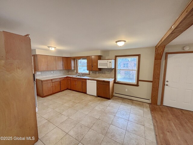3 Schuyler Ave, Ravena, NY 12143 - kitchen with white appliances, a baseboard radiator, a sink, light countertops, and tasteful backsplash