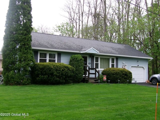 view of front of property with an attached garage, a shingled roof, a front yard, and driveway
