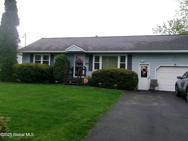 view of front of home with a garage, a front yard, asphalt driveway, and a shingled roof