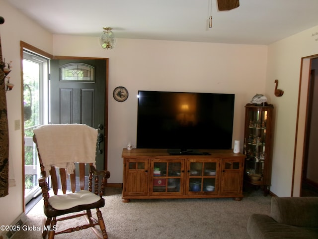 living area featuring plenty of natural light and light colored carpet