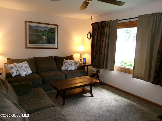living room with carpet flooring, a ceiling fan, and baseboards
