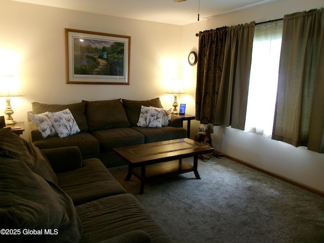 living room featuring carpet and baseboards