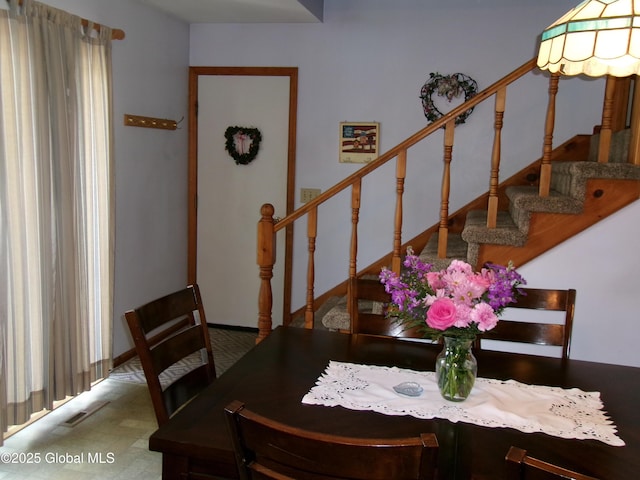 dining room featuring stairs