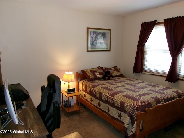 carpeted bedroom with an office area