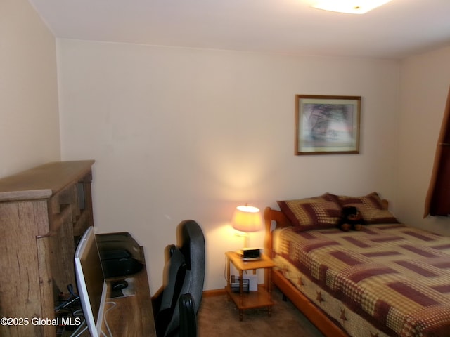 carpeted bedroom with a desk