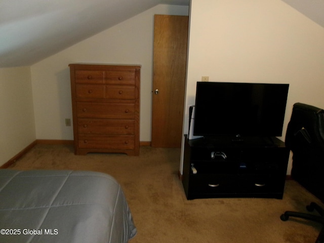 bedroom featuring carpet, lofted ceiling, and baseboards
