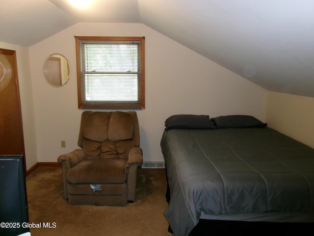 bedroom with vaulted ceiling, carpet floors, and baseboards